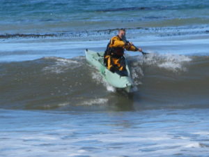 kayak surfing with a stable kayak from santa cruz kayaks