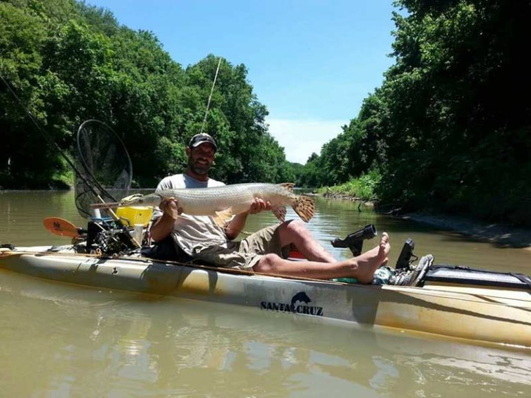 man on a santa cruz kayak with a caught large fish