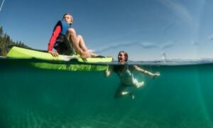 swimming alongside a kayak